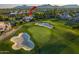 Panoramic view of the home nestled in a lush golf course community with mountain views; experience luxury and natural beauty at 7222 E Gainey Ranch Rd # 245, Scottsdale, AZ 85258