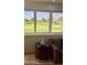 Stunning golf course view framed by bright windows, complemented by stylish interior accents and comfortable seating at 7222 E Gainey Ranch Rd # 245, Scottsdale, AZ 85258