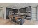 Stylish kitchen with gray cabinets, a kitchen island with bar seating, and modern stainless steel appliances at 7222 E Gainey Ranch Rd # 245, Scottsdale, AZ 85258