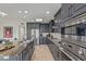 Modern kitchen with sleek grey cabinetry, stainless steel appliances, and granite countertops and an island at 7222 E Gainey Ranch Rd # 245, Scottsdale, AZ 85258