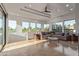 Bright living room featuring a neutral sectional couch, multiple windows with golf course views, and decorative ceiling at 7222 E Gainey Ranch Rd # 245, Scottsdale, AZ 85258
