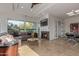 Spacious living room with a fireplace, large windows, tile floors and an open floor plan for entertaining guests at 7222 E Gainey Ranch Rd # 245, Scottsdale, AZ 85258