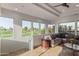 Bright living room with plush seating, travertine floors, stunning golf course views, and decorative ceiling details at 7222 E Gainey Ranch Rd # 245, Scottsdale, AZ 85258