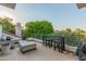 Relaxing outdoor patio area with comfortable seating, a bar table, and views of the lush green surroundings at 7222 E Gainey Ranch Rd # 245, Scottsdale, AZ 85258