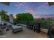 Outdoor patio featuring seating, a fire pit, a dining table, and views of the lush backyard at 7222 E Gainey Ranch Rd # 245, Scottsdale, AZ 85258