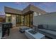 Stylish outdoor patio with comfortable seating, modern table, and sliding glass doors to the home interior at 7222 E Gainey Ranch Rd # 245, Scottsdale, AZ 85258
