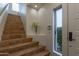 Inviting tiled staircase with white walls, bright lighting, and elegant decorative vase near the front door at 7222 E Gainey Ranch Rd # 245, Scottsdale, AZ 85258