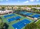 Aerial view showcasing multiple well-maintained tennis courts in a vibrant community setting at 7222 E Gainey Ranch Rd # 245, Scottsdale, AZ 85258