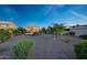 A spacious backyard with a covered patio, outdoor kitchen, gazebo, and gravel landscaping at 7230 W Pershing Ave, Peoria, AZ 85381