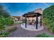 Gazebo and covered kitchen in a landscaped backyard at 7230 W Pershing Ave, Peoria, AZ 85381