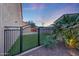 This backyard gate leads to lush artificial grass and landscaping at 7230 W Pershing Ave, Peoria, AZ 85381
