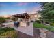 A backyard featuring an outdoor kitchen, covered patio, and spa, perfect for entertaining at 7230 W Pershing Ave, Peoria, AZ 85381