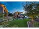 Backyard featuring an outdoor kitchen, grill, fireplace, spa and beautifully landscaped yard at 7230 W Pershing Ave, Peoria, AZ 85381