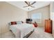 Relaxing bedroom features a double bed, ceiling fan, and a dedicated workspace at 7230 W Pershing Ave, Peoria, AZ 85381
