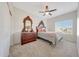 Cozy bedroom with plush carpet, ceiling fan, and antique wood dresser and mirror at 7230 W Pershing Ave, Peoria, AZ 85381