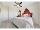 Comfortable bedroom featuring soft carpet, ceiling fan, and ornate wood headboard at 7230 W Pershing Ave, Peoria, AZ 85381