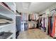 Large walk-in closet with built-in shelving and ample storage space for clothes and shoes at 7230 W Pershing Ave, Peoria, AZ 85381