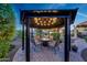 Outdoor space with a gazebo, charming string lights, and comfortable seating around a central fire pit at 7230 W Pershing Ave, Peoria, AZ 85381