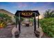 Backyard gazebo featuring a fire pit and seating at 7230 W Pershing Ave, Peoria, AZ 85381