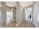 Wide shot of hallway featuring wood floors, white doors, and access to the bedrooms at 7230 W Pershing Ave, Peoria, AZ 85381