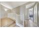 Open hallway features wood-style floors, white railings, and leads to the living room at 7230 W Pershing Ave, Peoria, AZ 85381
