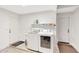 Well-lit laundry room features a sink, washer, dryer, shelving, and convenient access to doors at 7230 W Pershing Ave, Peoria, AZ 85381