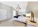 Large bedroom featuring a ceiling fan, carpet floors, and views to the bathroom at 7230 W Pershing Ave, Peoria, AZ 85381