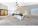 Spacious main bedroom boasts a ceiling fan, carpet floors, and ample natural light at 7230 W Pershing Ave, Peoria, AZ 85381