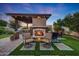 Inviting outdoor living space with a stone fireplace, pergola, and comfortable seating for relaxing evenings at 7230 W Pershing Ave, Peoria, AZ 85381