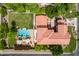 Overhead view of a home with a red tile roof, pool, manicured lawn, and well-maintained landscaping at 7236 W Electra Ln, Peoria, AZ 85383