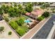 Aerial view of a two-story home with a swimming pool, grassy yard, garden, and tile roof at 7236 W Electra Ln, Peoria, AZ 85383
