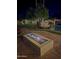 Backyard with a fire pit, stone bridge feature, pool, and garden at 7236 W Electra Ln, Peoria, AZ 85383