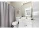 Bathroom showcasing a single sink vanity, toilet, and a bathtub with shower at 7236 W Electra Ln, Peoria, AZ 85383