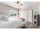Bright bedroom with a ceiling fan, shuttered windows, and ensuite sliding door closet at 7236 W Electra Ln, Peoria, AZ 85383