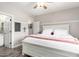 Bedroom featuring a white bed frame, ceiling fan, and an ensuite door to the bathroom at 7236 W Electra Ln, Peoria, AZ 85383