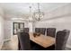 Charming dining room with seating for eight under decorative lighting and glass paneled doors at 7236 W Electra Ln, Peoria, AZ 85383