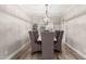 Elegant dining room with upholstered chairs, a chandelier, and neutral walls at 7236 W Electra Ln, Peoria, AZ 85383