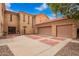 Stunning two-story home with a red tile roof, three-car garage, brick driveway, and desert landscaping at 7236 W Electra Ln, Peoria, AZ 85383