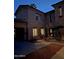 Exterior night view of a two-story home featuring a porte-cochere, fountain, and desert landscaping at 7236 W Electra Ln, Peoria, AZ 85383