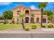 Charming two-story home with a red tile roof, stone accents and a manicured lawn at 7236 W Electra Ln, Peoria, AZ 85383