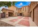 Charming two-story home with stucco siding, a red tile roof, and an inviting brick driveway with a fountain at 7236 W Electra Ln, Peoria, AZ 85383