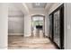 Hallway view features wood floors, neutral paint, and intricate double doors at 7236 W Electra Ln, Peoria, AZ 85383