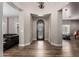 Bright foyer with an intricate front door, wood floors, and neutral paint at 7236 W Electra Ln, Peoria, AZ 85383