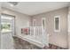 Bright hallway with wood-look floors, white railings, and ample natural light from window shutters at 7236 W Electra Ln, Peoria, AZ 85383