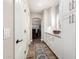 Hallway leading to a dining room with wood floors and bright white cabinets at 7236 W Electra Ln, Peoria, AZ 85383