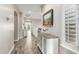 Bright hallway with wood floors, decorative cabinet, and natural light at 7236 W Electra Ln, Peoria, AZ 85383