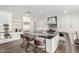 Contemporary kitchen with marble countertops, a large island, and stainless steel appliances at 7236 W Electra Ln, Peoria, AZ 85383