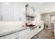 Modern kitchen featuring white cabinets, granite countertops, and stainless steel appliances at 7236 W Electra Ln, Peoria, AZ 85383