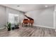 Spacious living room with a brown grand piano and a large window at 7236 W Electra Ln, Peoria, AZ 85383