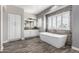 Luxurious main bathroom featuring a soaking tub, modern fixtures, and ample storage space at 7236 W Electra Ln, Peoria, AZ 85383
